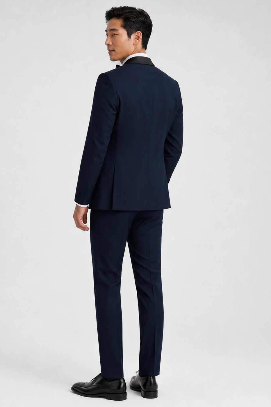 Man wearing a navy suit on a white background